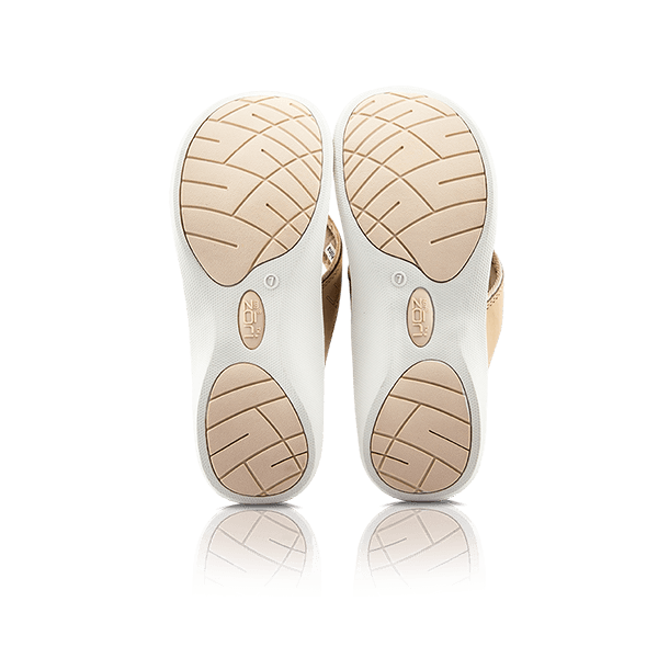 Neat Zori Blush Slimline Orthotic Thong, both sandals flipped to show their underside, mostly white with cream pads, displayed side by side.